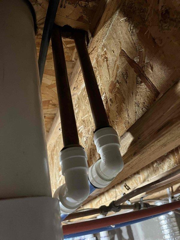 Responded to reported water leak in basement initially suspected to be from infloor heating system. Upon inspection, determined that moisture was not from HVAC equipment or infloor heat system, but rather from condensation forming on cold water supply lines due to elevated humidity levels in the space. Inspected exposed plumbing infrastructure, refrigerant lines, and ductwork in basement area to rule out any HVAC-related leaks or failures. Documented conditions with photos showing building systems, including PVC plumbing, copper refrigerant lines, and sheet metal ductwork. Advised customer that issue is related to humidity control rather than equipment malfunction. Provided estimate options for mini-split system installation to address comfort and humidity concerns.