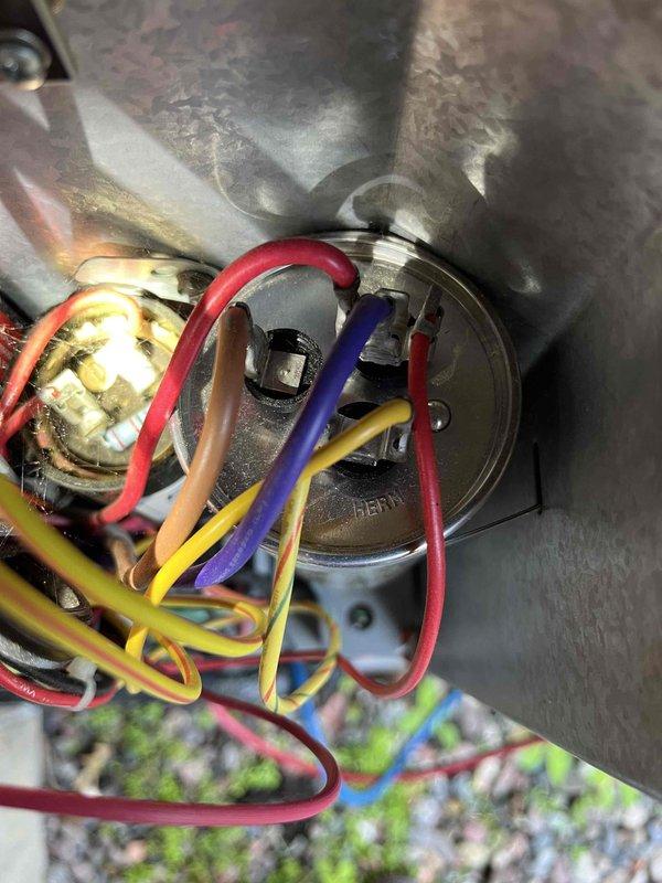 Completed annual partner plan inspection on 11-year-old AC system. Found capacitor reading below acceptable range and suction pressure levels off due to TXV valve malfunction affecting refrigerant flow. Documented electrical connections and wiring assembly with photos showing multiple wire terminals, contactor, and capacitor assembly. Provided estimates for necessary repairs to restore system to optimal operating condition.