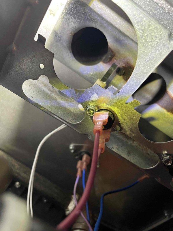 Completed Partner Plan annual maintenance inspection on furnace system. During inspection, identified mild corrosion on the igniter assembly with heat-related discoloration visible on mounting bracket and surrounding components. Documented condition with photos showing affected igniter assembly and burner components. Provided estimate for igniter replacement to prevent potential failure during heating season.