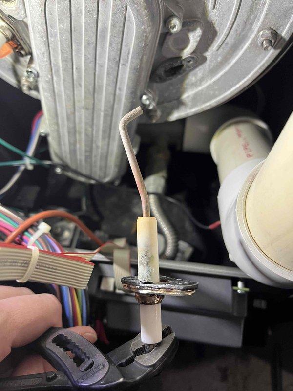 Completed Partner Plan annual inspection on 12-year-old boiler system. Upon combustion analysis, discovered elevated carbon monoxide levels in exhaust gases. Identified root cause as gas valve incorrectly configured for propane instead of natural gas. Adjusted gas valve settings to proper natural gas specifications, resulting in combustion readings returning to normal operating parameters. Inspected flame sensor and igniter, noting mild corrosion present on both components. Documented system condition with photographs showing accumulated dust on blower assembly and corroded flame sensor. Provided estimates for recommended component replacement to prevent future operational issues.