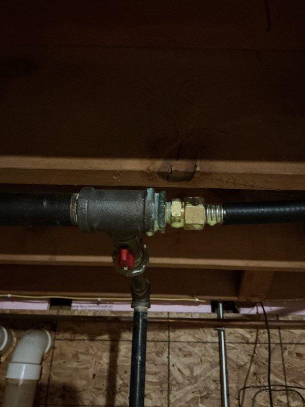 Installed new gas line to supply appliance per approved estimate. Ran black flexible gas pipe through basement/crawl space with proper fittings and shut-off valve, terminating at interior location with chrome gas valve assembly at floor level. All connections secured with appropriate compression fittings and tested for safe operation.