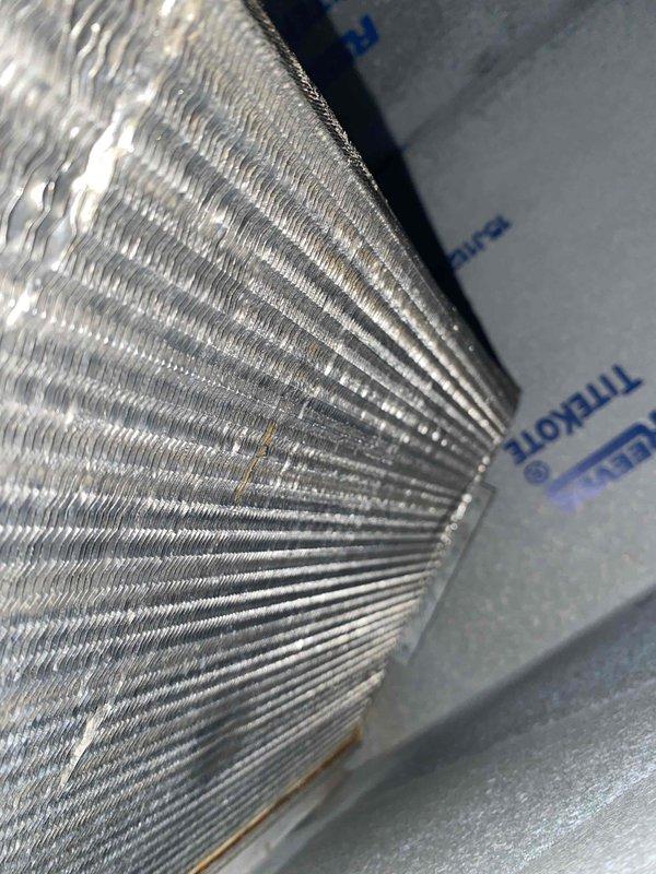 Responded to service call for air conditioning system not keeping up with cooling demand. Upon inspection, found all system components operating within normal parameters. Examined condenser coil and evaporator coil, documenting existing condition with photos showing minor dust accumulation between fins and evidence of corrosion on copper refrigerant lines. System functionality verified with no immediate repairs required at time of service.