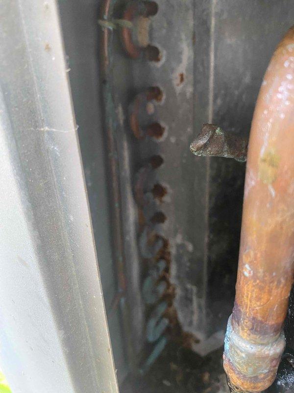 Responded to service call for air conditioning system not keeping up with cooling demand. Upon inspection, found all system components operating within normal parameters. Examined condenser coil and evaporator coil, documenting existing condition with photos showing minor dust accumulation between fins and evidence of corrosion on copper refrigerant lines. System functionality verified with no immediate repairs required at time of service.
