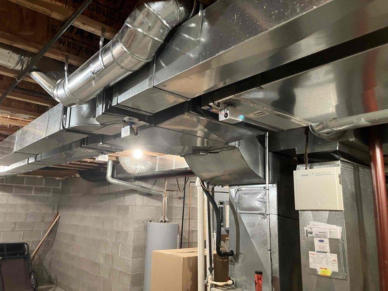 Responded to complaint of insufficient airflow to upstairs bedroom in home with 11-year-old air conditioning system. Upon inspection, identified improperly designed zone damper system and inadequate duct venting in attic space. Evaluated existing ductwork configuration and zoning controls, confirming poor air distribution throughout second floor. Recommended complete replacement of zoning system to resolve airflow deficiencies and improve comfort in affected areas.