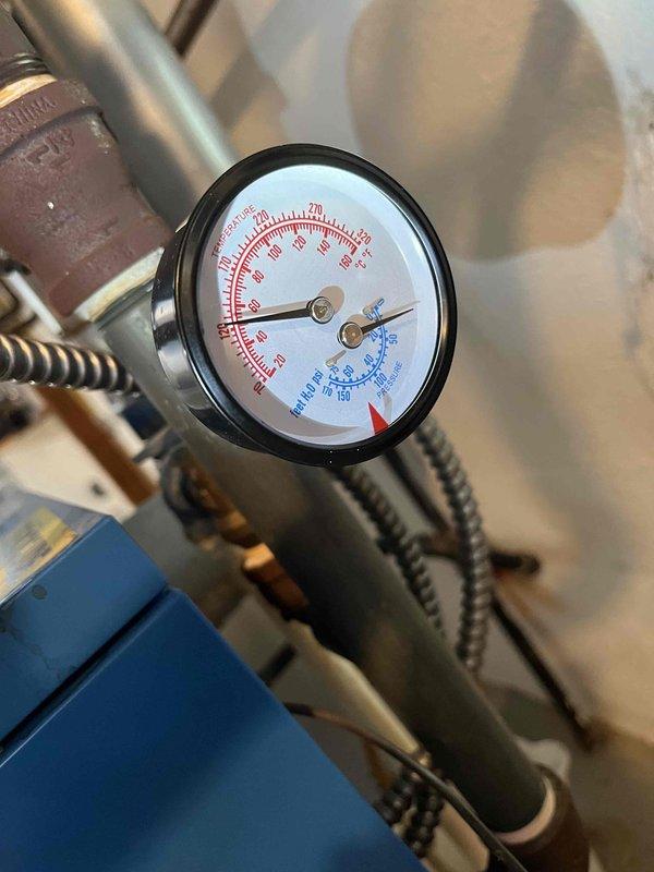 Responded to service call for boiler gauge replacement. Upon arrival, contacted customer to obtain lock code for system access. Successfully replaced faulty pressure gauge and pressure tank on boiler system. System pressure readings verified and operational parameters confirmed within normal range following installation.