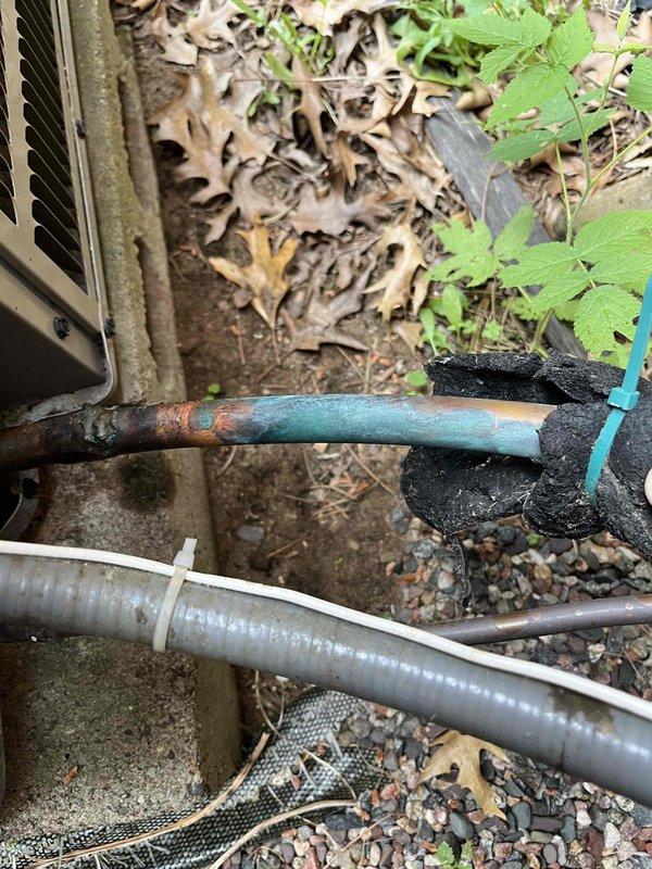 Responded to no cooling complaint on 12-year-old air conditioning system. Upon inspection, discovered low refrigerant levels in the unit. Performed visual inspection of refrigerant lines, noting significant corrosion and oxidation on copper piping, particularly at connection points and exterior-mounted components. The advanced deterioration of the refrigerant lines suggests potential leak points requiring further diagnostic testing. Recommended comprehensive leak test to identify exact location of refrigerant loss and provided comfort advisor consultation option for system replacement consideration given the age and condition of the equipment.