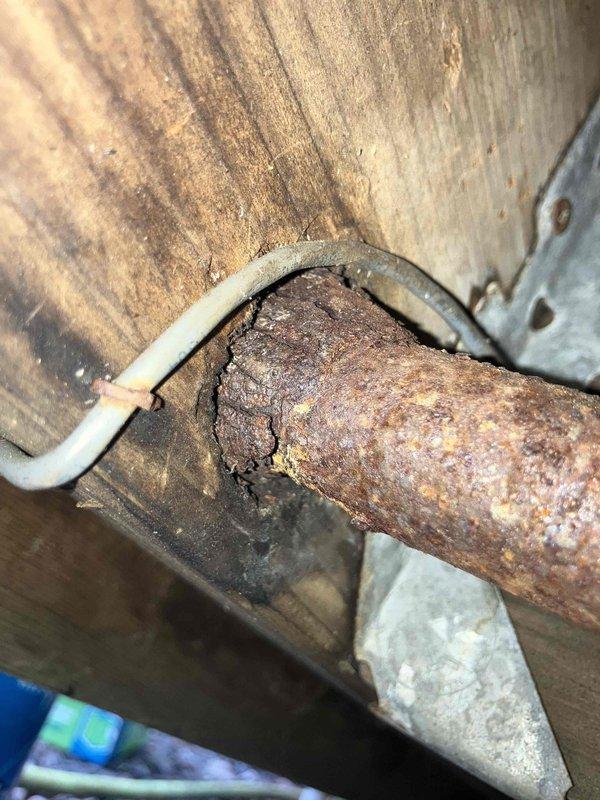 Responded to gas leak investigation request and successfully located active leak in underground natural gas piping running beneath deck structure. Upon inspection, identified severely corroded 10-foot section of metal pipe exhibiting extensive rust deterioration, flaking, and compromised integrity. The corroded pipe showed brownish-red oxidation and crusty surface texture indicating advanced age and weathering. Replaced failed pipe section with new gas line to eliminate leak and restore safe gas service. Completed all necessary documentation and safety verification procedures.