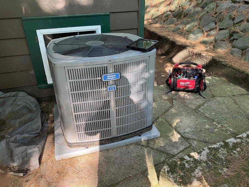 Responded to no cooling complaint on 11-year-old American Standard air conditioning system. Upon arrival, confirmed compressor was not engaging and unit was producing no cool air. Diagnostic testing revealed a failed dual run capacitor preventing compressor operation. Additionally, discovered system was completely void of refrigerant charge. Replaced the defective capacitor with new component and performed thorough leak check of the refrigeration system to identify source of refrigerant loss before recharging. System restored to operational status.