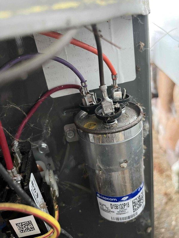 Responded to no cooling call on approximately 15-year-old HVAC system. Upon inspection, found failed dual-run capacitor on outdoor condensing unit, preventing compressor operation. Unit interior showed significant dust and debris accumulation consistent with age and lack of maintenance. Replaced defective capacitor and restored system to normal cooling operation.