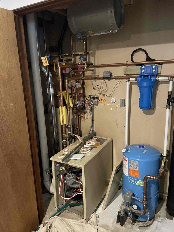 Supplied and installed a 50-gallon Bradford White LP power-vent water heater in the utility room as part of a combination installation with furnace and AC system. Connected all copper supply lines, electrical conduit, and exhaust venting to manufacturer specifications, ensuring proper integration with existing well pressure tank and water filtration system.