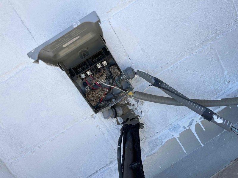 Responded to no cooling complaint on rooftop unit. Upon inspection, identified failed capacitor with visible deterioration and damaged power whip conduit. Breaker exhibited abnormal noise when system shut off, indicating potential electrical hazard. Discovered authorization discrepancy as building owner was not informed of service call or equipment issues by tenant who scheduled appointment. Due to lack of proper authorization from property owner, discontinued service and did not proceed with repairs for safety and liability reasons.