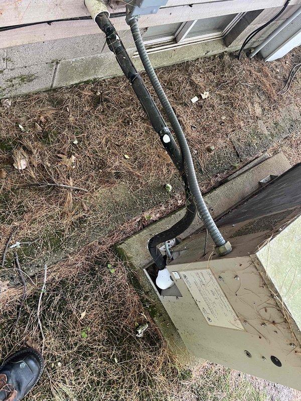 Upon arrival, found the air conditioning system running but unable to maintain temperature below 78 degrees. Inspection revealed extensive ice buildup from the evaporator coil through the refrigerant lines extending all the way to the compressor and accumulator. The outdoor unit showed signs of age with weathering and debris accumulation around the base. The indoor compartment displayed significant dust, cobwebs, and lack of recent maintenance. Documented the iced refrigerant system and overall condition of the aging equipment with photos. Provided estimates for necessary repairs to restore proper cooling operation.