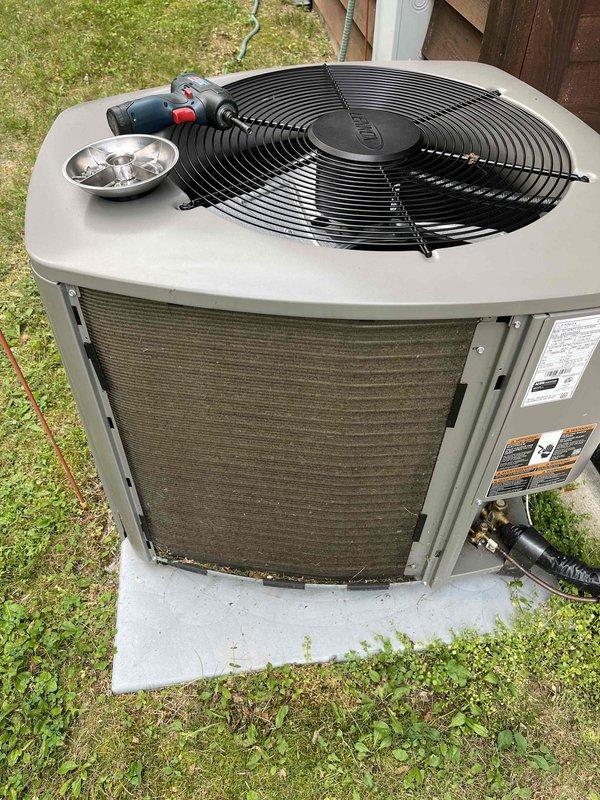 Completed prepaid annual air conditioning inspection on outdoor condenser unit. During testing, discovered capacitor reading low, which caused the condenser fan motor to fail to operate properly. Performed warranty replacement of defective capacitor and restored system to normal operation at time of service.