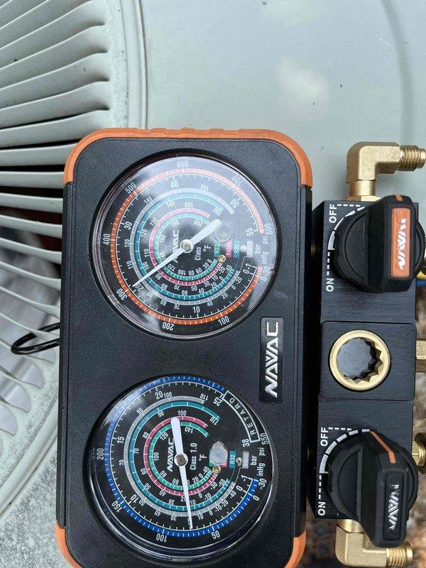 Completed partner plan inspection on Trane system. Found pollen buildup on condenser coil causing elevated liquid line pressure, failed capacitor, buzzing contactor, dirty humidifier pad, dirty blower filter, and aged hard start kit. Documented system conditions with pressure readings using gauge manifold and photographed failed capacitor showing dust accumulation and deteriorated condition. Blower wheel requires cleaning for optimal airflow. Provided estimates for necessary repairs and component replacements to restore system to proper operating condition.
