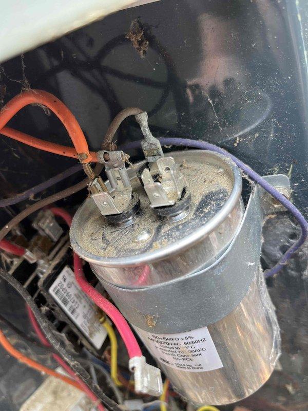 Completed partner plan inspection on Trane system. Found pollen buildup on condenser coil causing elevated liquid line pressure, failed capacitor, buzzing contactor, dirty humidifier pad, dirty blower filter, and aged hard start kit. Documented system conditions with pressure readings using gauge manifold and photographed failed capacitor showing dust accumulation and deteriorated condition. Blower wheel requires cleaning for optimal airflow. Provided estimates for necessary repairs and component replacements to restore system to proper operating condition.