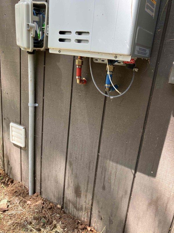 Installed LP gas piping to connect tankless water heater located in exterior insulated building. Ran new gas line from existing supply point near furnace approximately 5 feet to outdoor on-demand water heater, including necessary fittings, shut-off valve, and flexible connectors. Previous installer had completed water heater installation but was unable to complete gas line connection, requiring our gas piping expertise to finalize the installation and make unit operational.