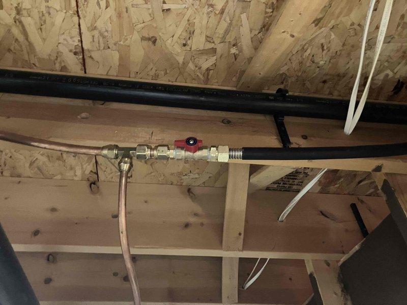 Installed new gas piping with flare fittings and brass shut-off valve with red handle in utility space. Completed professional installation with proper compression fittings and secure mounting to ensure safe gas line operation.