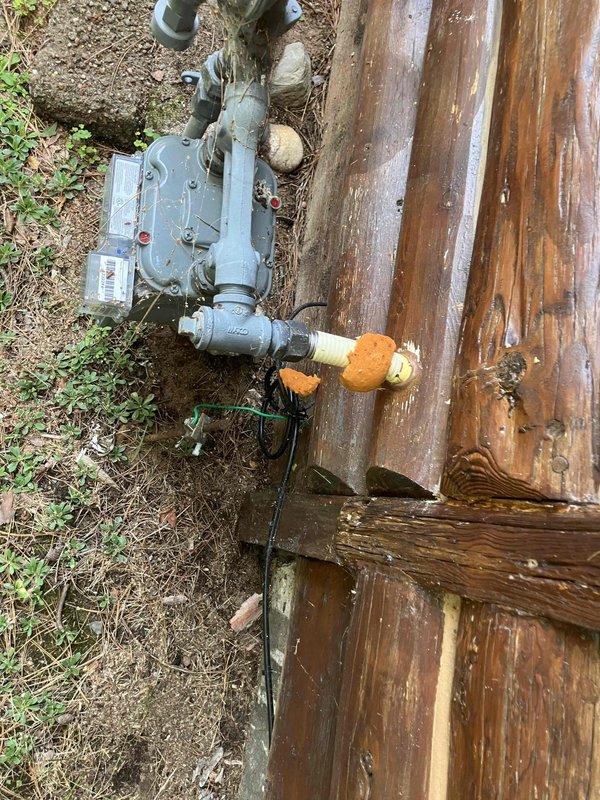 Responded to service call for non-operational crawlspace dehumidifier and non-compliant gas piping. Upon inspection, diagnosed failed blower motor in dehumidifier unit. Identified code violation at gas meter where TracPipe flexible gas line installation did not meet current safety standards. Documented existing conditions with photos showing weathered gas meter assembly with improper piping connections and crawlspace environment with moisture present on surfaces. Provided estimate for blower motor replacement and complete gas line replacement from meter to ensure code compliance.