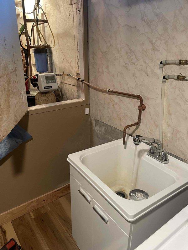 Completed annual prepaid plumbing inspection on water conditioning system. Inspected ProMate water softener unit with digital control head and pre-filter housing, verified all components operating within normal parameters, checked plumbing connections and system performance. System functioning properly with no issues identified.