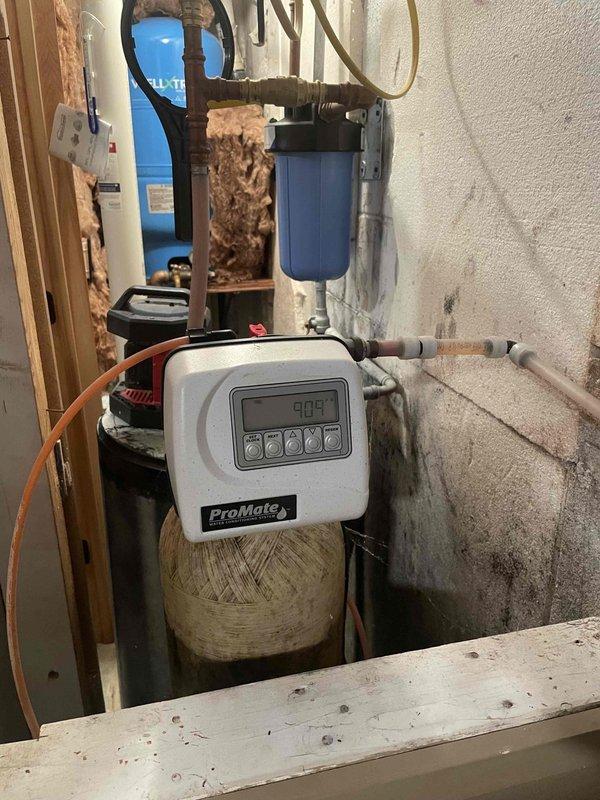 Completed annual prepaid plumbing inspection on water conditioning system. Inspected ProMate water softener unit with digital control head and pre-filter housing, verified all components operating within normal parameters, checked plumbing connections and system performance. System functioning properly with no issues identified.