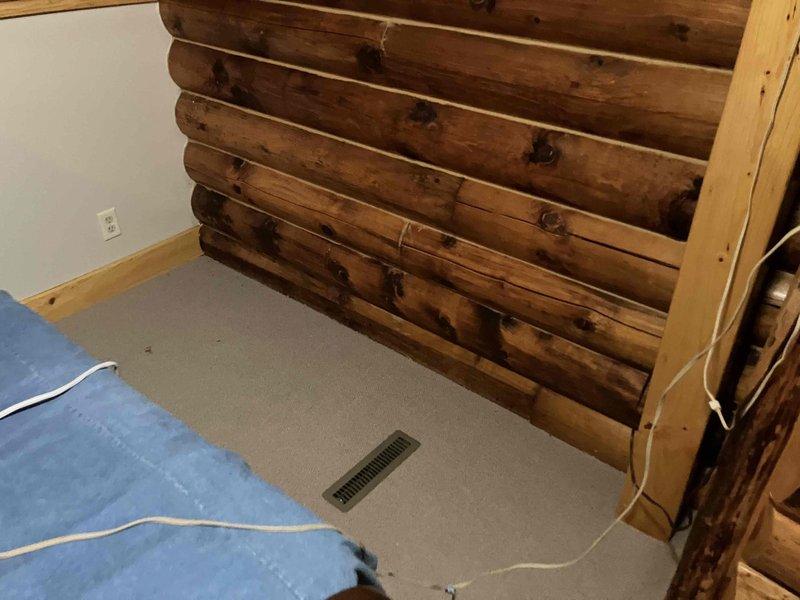 Responded to service call for high humidity and mold issues in loft area of log cabin structure. Assessed indoor air quality conditions and ventilation system performance. Customer reported dehumidifier filling rapidly, indicating excessive moisture levels in the space. Evaluated existing HVAC system including mini-split unit and whole home humidifier operation. Documented interior and exterior conditions of loft area, noting log construction and current ventilation provisions. Provided professional recommendations for improved air circulation and humidity control solutions to address ongoing moisture concerns and prevent further mold growth.
