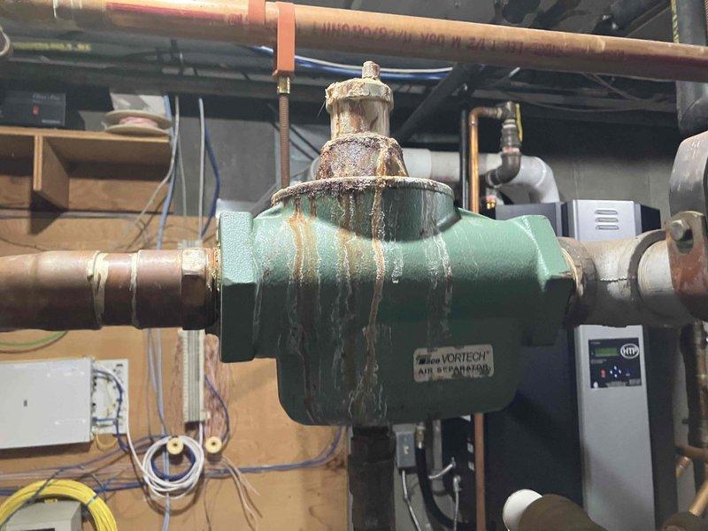 Responded to no heat call on 12-year-old HTP Elite FT boiler system with zoned heating distribution. Upon inspection, diagnosed multiple system failures including failing circulation pumps preventing heat distribution to upper floors, deteriorated air separator with extensive rust and corrosion compromising system efficiency, and failed pressure gauge requiring replacement. Provided three separate repair estimates to address the identified equipment failures and restore proper heating operation to the multi-zone hydronic system.