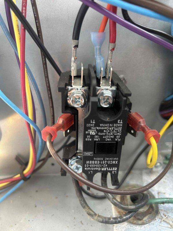 Completed second quarterly preventive maintenance inspection on residential HVAC system as part of routine maintenance agreement. Inspected electrical contactor with multi-wire connections, verified proper termination of all conductors and switching mechanism operation. Documented vertically-stacked utility closet configuration including air handler, water heater, and associated controls with photographic records for maintenance history.