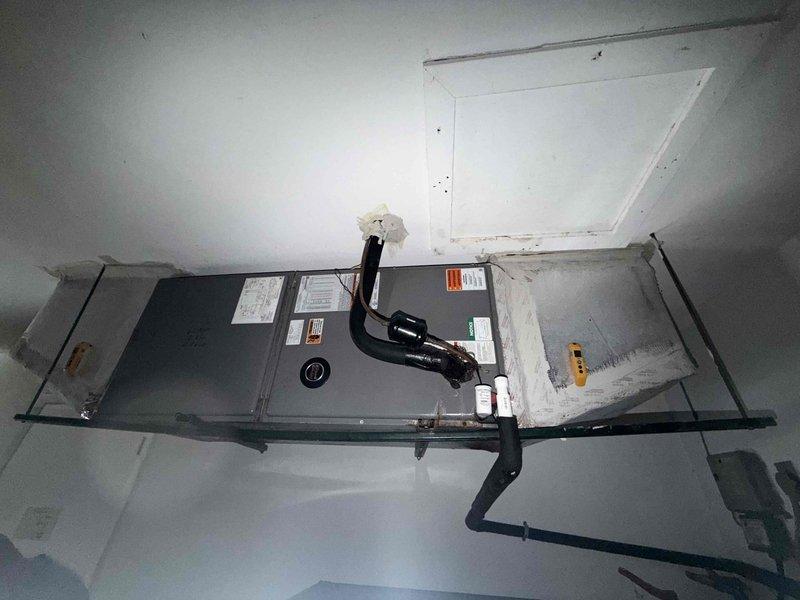 Cape Coral, FL - Responded to no cooling complaint on residential split system. Customer reported unit failed to cool after being turned off for several hours. Performed diagnostic inspection of outdoor condensing unit and indoor air handler. Documented equipment condition and installation with photos showing outdoor unit on concrete pad with proper clearances and indoor air handler ceiling-mounted in attic space. Refrigerant lines and electrical connections inspected at both indoor and outdoor components. System evaluated for proper operation and potential causes of cooling failure identified for repair recommendations.