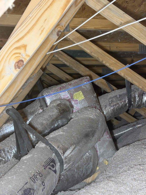 Completed third quarterly preventive maintenance inspection on HVAC system. Documented significant contamination on evaporator coil fins with dark streaking, biological growth, and microbial buildup concentrated along center seam, indicating prolonged moisture exposure and need for cleaning during next service interval. Inspected attic space and verified insulation materials stored properly among floor joists with electrical wiring routed appropriately through roof structure.