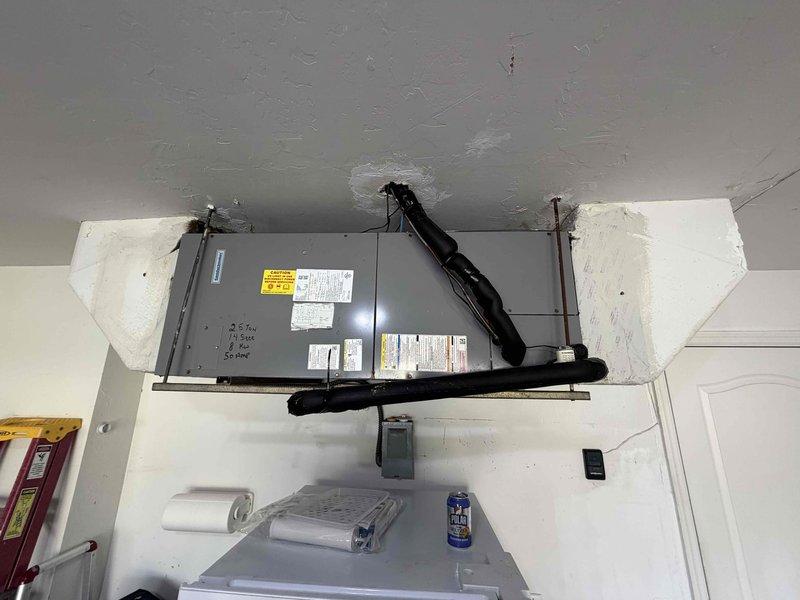 Completed preventive maintenance inspection on residential HVAC system as part of scheduled 2 of 4 maintenance visits. Serviced both indoor air handler unit located in elevated utility space and outdoor condensing unit mounted on concrete pad against building exterior. Performed standard maintenance procedures including system inspection, filter check, and operational testing of both interior and exterior components. Documentation captured showing proper installation of equipment with appropriate electrical connections, refrigerant lines, and mounting hardware all in serviceable condition.