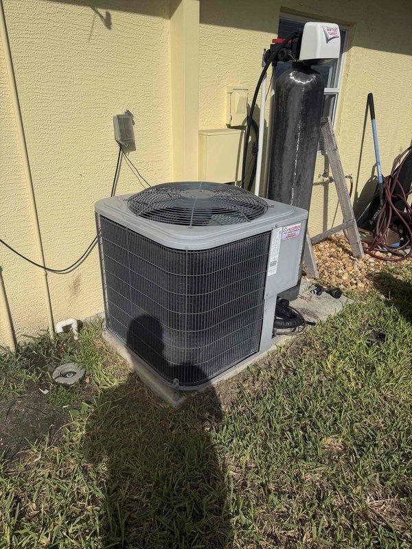 Completed preventive maintenance inspection on residential HVAC system as part of scheduled 2 of 4 maintenance visits. Serviced both indoor air handler unit located in elevated utility space and outdoor condensing unit mounted on concrete pad against building exterior. Performed standard maintenance procedures including system inspection, filter check, and operational testing of both interior and exterior components. Documentation captured showing proper installation of equipment with appropriate electrical connections, refrigerant lines, and mounting hardware all in serviceable condition.
