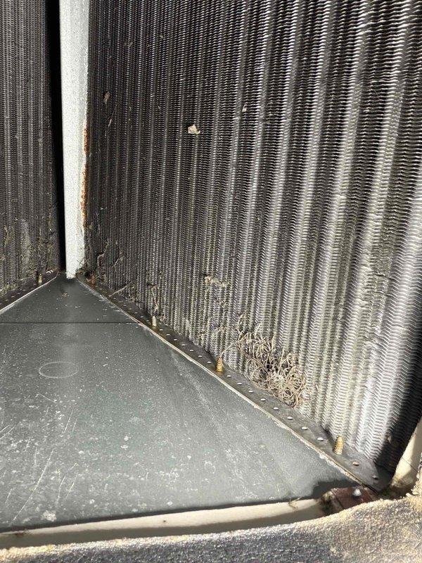 Fort Myers, FL - Responded to service call for AC unit experiencing intermittent operation and no cooling. Upon inspection, found significant debris and dirt accumulation on evaporator coil fins, with heavy buildup of lint and fibrous material concentrated in lower sections restricting airflow. Blower wheel assembly showed substantial dust and debris accumulation on blades affecting system performance. Documented current condition of both components with photographs for maintenance records. Unit requires thorough cleaning of evaporator coil and blower wheel to restore proper airflow and cooling capacity.