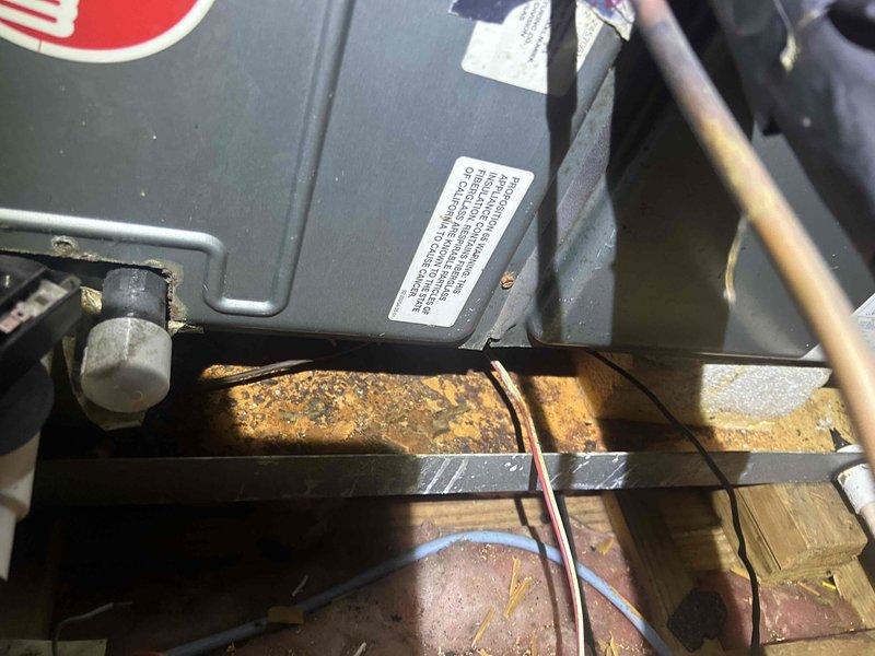 Cape Coral, FL - Completed third quarterly preventive maintenance inspection on HVAC system as part of routine maintenance agreement. Inspected ductwork in attic space, verifying proper installation and sealing of flexible duct runs with reflective tape, confirmed adequate insulation coverage between floor joists, and examined mechanical equipment housing. Documented significant rust and corrosion on metal support bracket beneath equipment, indicating ongoing moisture exposure that will require monitoring and potential future remediation to prevent structural compromise of equipment mounting system.