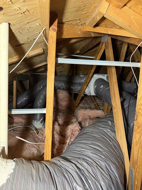 Cape Coral, FL - Completed routine maintenance inspection on attic-mounted HVAC system as the fourth and final service visit under the 2 Year Catalyst Membership program. Performed comprehensive visual assessment of dual air handler configuration, refrigerant line connections, and associated ductwork. Documented existing ceiling moisture staining near refrigerant line penetration and verified proper mounting of equipment on support brackets. Inspected flexible ductwork routing through attic space, insulation condition, and electrical connections. System operational at time of service completion. Customer departing at 1pm as scheduled and has enrolled in new membership for continued coverage.