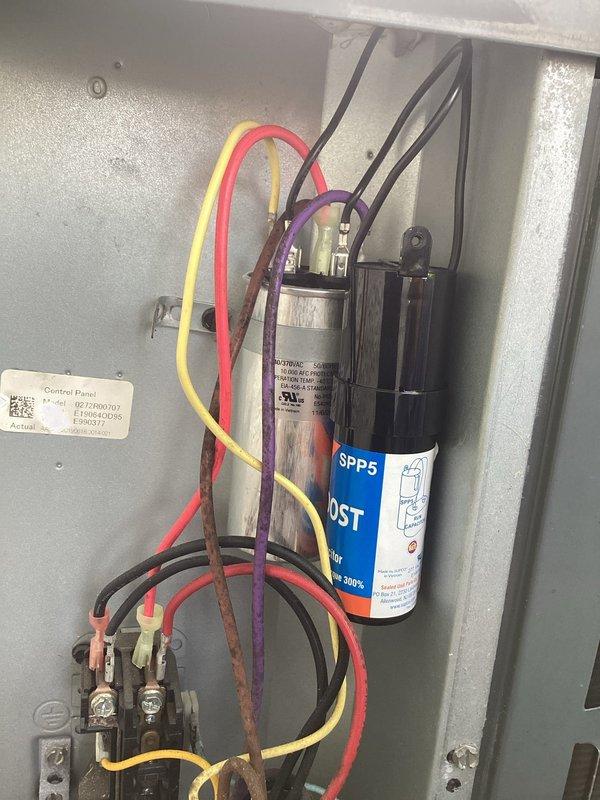 Installed a hard start capacitor on a residential air conditioning condenser unit to improve compressor starting performance and reduce strain on the electrical system. The SPP5 hard start kit was properly wired and secured within the existing electrical control panel, with all connections verified for proper operation.