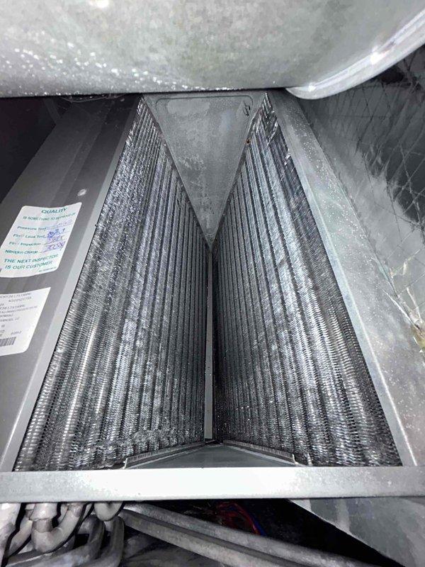 Completed routine preventive maintenance inspection on HVAC air handler unit as part of scheduled maintenance agreement. Inspected A-frame evaporator coil assembly, confirmed coils in clean operational condition with proper fin spacing and metallic integrity intact. Examined drain pan for proper drainage and noted typical operational wear with minor discoloration. Evaluated electrical components including capacitor assembly, verified wire connections and terminal integrity, observed signs of carbon buildup on terminals indicating potential future service needs. Documented system conditions through photographic records for maintenance history tracking.