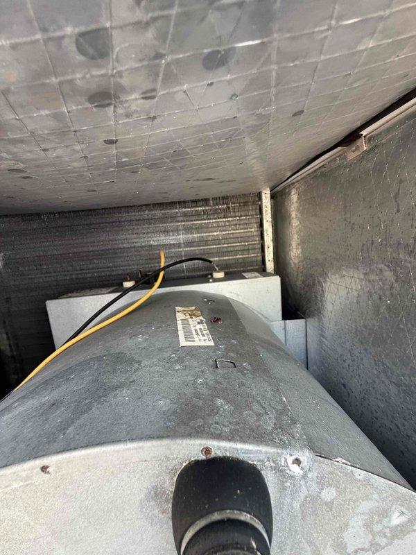 Performed the third of four scheduled preventive maintenance inspections on the HVAC system under the 2 Year Catalyst Membership. Inspected the outdoor unit's cabinet, data plate, duct/plenum seam tape, and electrical junction box, noting light surface wear and a minor spot of rust on the junction box with no frost or major damage observed. Inspected the air handler interior, including the evaporator coil, blower housing, insulation, wiring, and control connections, noting dust accumulation on the coil and corrosion on the blower housing.