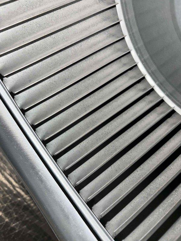 Performed the first of four scheduled preventive maintenance visits under the 2-year Catalyst membership, inspecting the outdoor condenser unit and the indoor air handler. Inspected the condenser, disconnect, refrigerant line set, and condensate drain, with no frost, ice, rust, or damage observed. Inspected the blower wheel and found a heavy accumulation of fine dust and grime across the blades, a condition that reduces airflow and system efficiency.