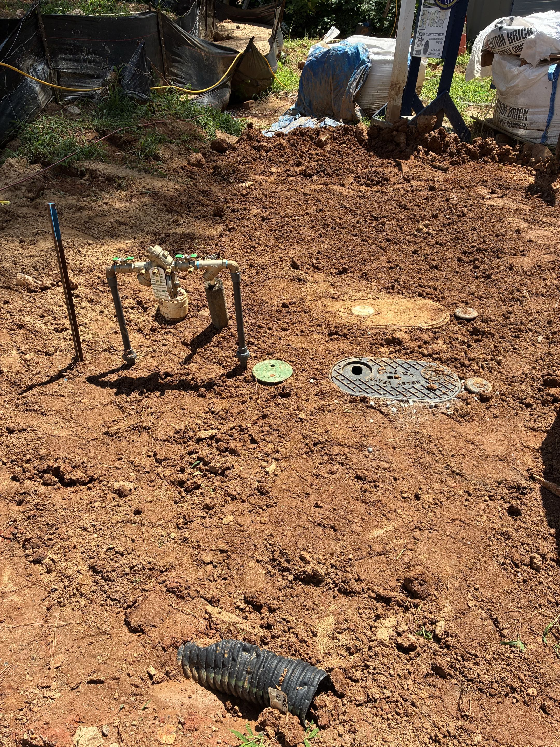Raleigh, NC - A domestic water line was accessed before the existing water meter. A new water meter was installed to accurately measure residential water usage. An RPZ Reduced Pressure Zone valve was added to safeguard the plumbing system from backflow issues, ensuring safety and regulatory compliance. An irrigation meter was also installed to separately track water used for irrigation, promoting efficient water management. This meter split configuration allows for distinct monitoring of domestic and irrigation water usage. The installation was executed with precision to ensure optimal performance and reliability of the water system. Each component was carefully installed to maintain system integrity and functionality.