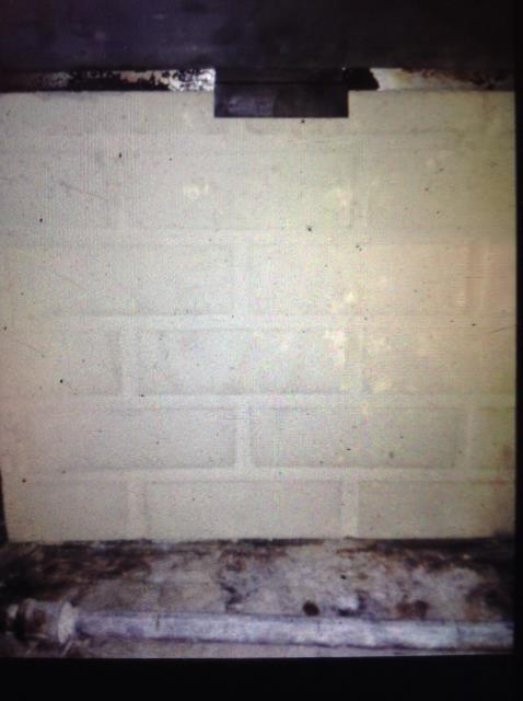  Installing a back panel and a reflector shield to bring the fireplace up to code.