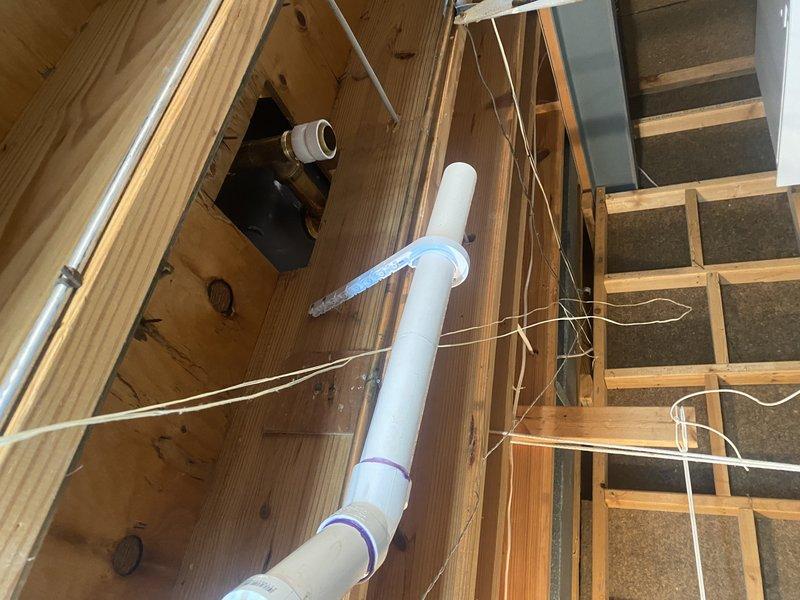 Completed replacement of cast iron waste lines with PVC for water closet, lavatory, and tub-shower assembly per permit requirements. Installed new piping through floor joists with proper supports and connections, including appropriate venting. Prepared system for rough inspection before owner completes wall, ceiling, and floor finishes.
