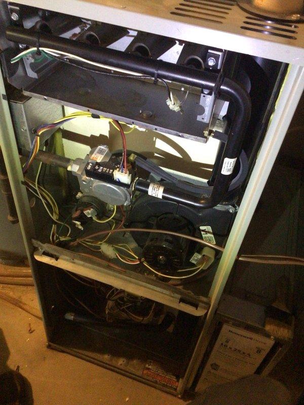 Performed scheduled heating tune-up on 16-year-old furnace located in basement. Inspected Honeywell digital thermostat (reading 67°F with 70°F setpoint) and verified proper operation. Opened unit to examine internal components including blower assembly, control board, and wiring connections - all found to be functioning normally with no issues detected.