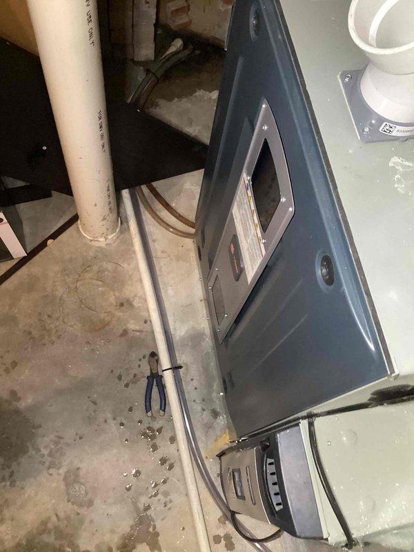 Responded to service call for dehumidifier drain tube replacement in basement unit (2020 model). Upon inspection, accessed the dehumidifier housing to evaluate the drain system. Removed deteriorated drain tube and installed new compatible replacement, ensuring proper connection and routing to prevent future moisture issues. Verified system operation and confirmed proper drainage function before completing service.