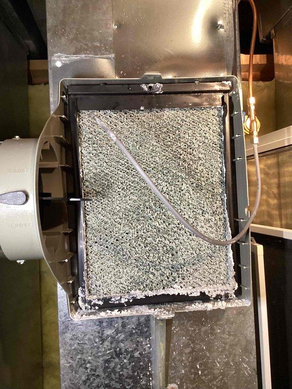 Responded to service call for dehumidifier drain tube replacement in basement unit (2020 model). Upon inspection, accessed the dehumidifier housing to evaluate the drain system. Removed deteriorated drain tube and installed new compatible replacement, ensuring proper connection and routing to prevent future moisture issues. Verified system operation and confirmed proper drainage function before completing service.