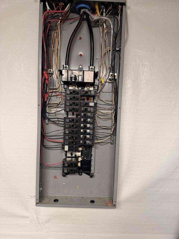 Performed comprehensive electrical panel inspection and service entrance assessment. Main distribution panel exhibited properly installed circuit breakers with standard color-coded wiring (red, white, black, and yellow conductors) in organized configuration. Exterior meter installation, conduit system, and grounding connections were examined and found to be in standard working condition with no visible deterioration or code violations.