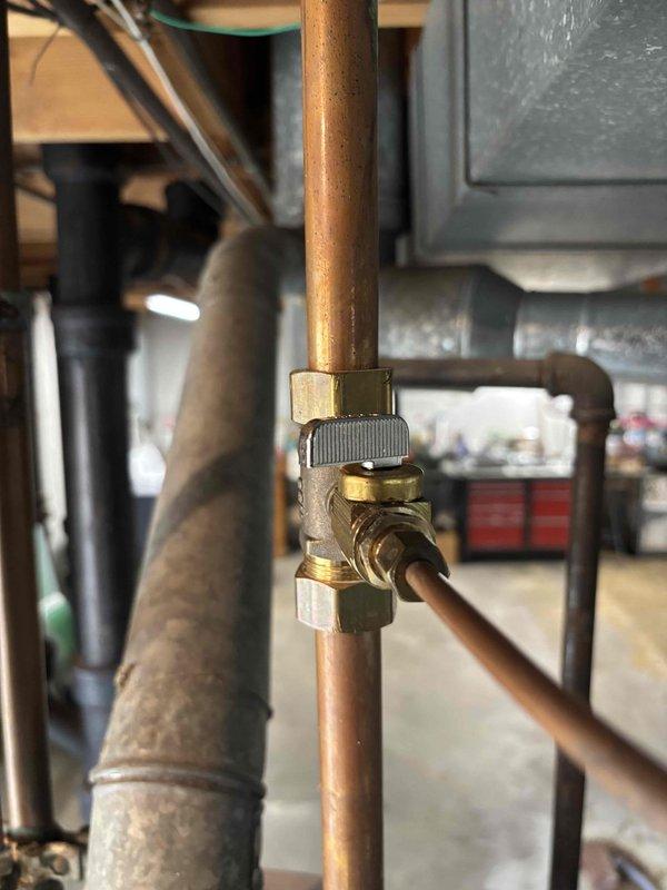 Inspected humidifier in basement where leaking was reported at hose connection. Examined copper plumbing assembly with brass valve and control components. Verified proper operation of HVAC system including filter condition and ductwork connections.