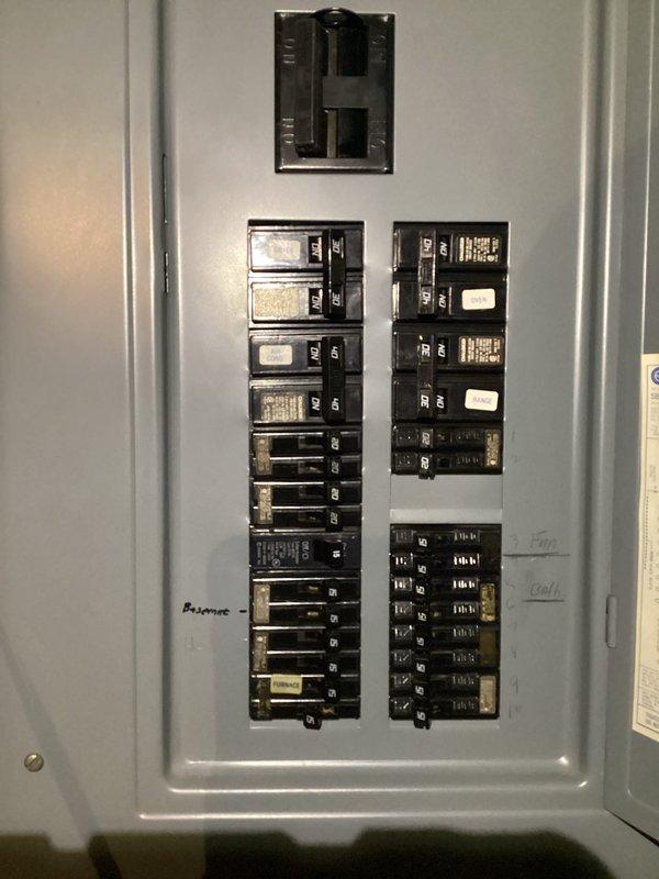 Completed complimentary electrical inspection of residential property. Examined unfinished basement/utility area with exposed electrical wiring, HVAC components, and plumbing infrastructure. Inspected main electrical panel, documenting circuit breaker configuration and labeling for safety compliance and load distribution assessment.