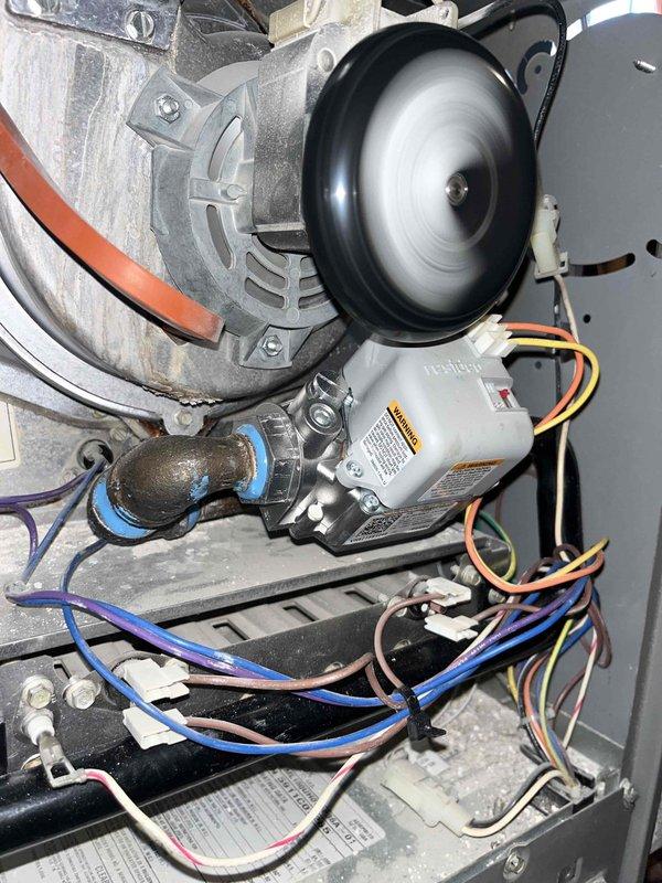 Diagnosed no-heat issue with furnace in basement. Inspected system and found blower motor operating properly as evidenced by spinning fan wheel. Verified electrical connections to control board were secure with all wiring (yellow, blue, red, white) intact and properly terminated.