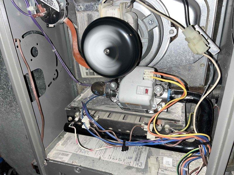 Diagnosed no-heat issue with furnace in basement. Inspected system and found blower motor operating properly as evidenced by spinning fan wheel. Verified electrical connections to control board were secure with all wiring (yellow, blue, red, white) intact and properly terminated.