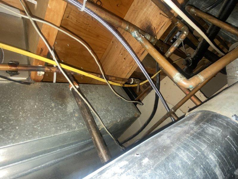 Successfully installed a 50-gallon gas tall water heater and completed gas line modifications to accommodate the unit. Removed existing copper gas piping in basement and installed new copper press gas components including tees, couplings, and valves according to code requirements. Routed approximately 10' of flexible gas piping to kitchen floor, which required drilling to widen subfloor hole for proper installation.